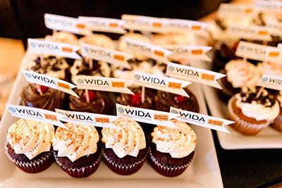 trays of cupcakes with mini WIDA flags on toothpicks