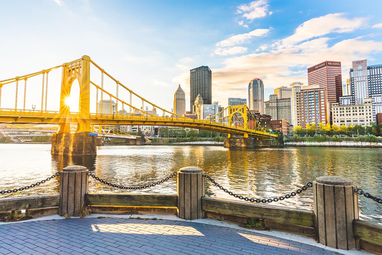 skyline of pittsburgh with bridge over river in foreground